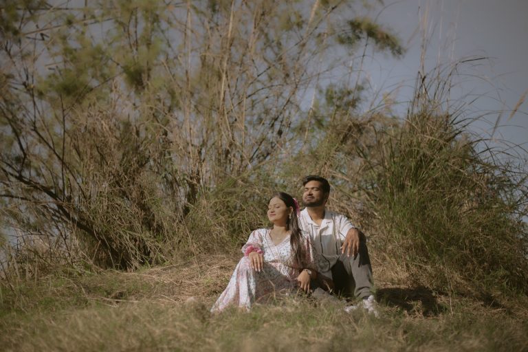 Best photographer near me reviewing wedding photos with clients in Delhi NCR